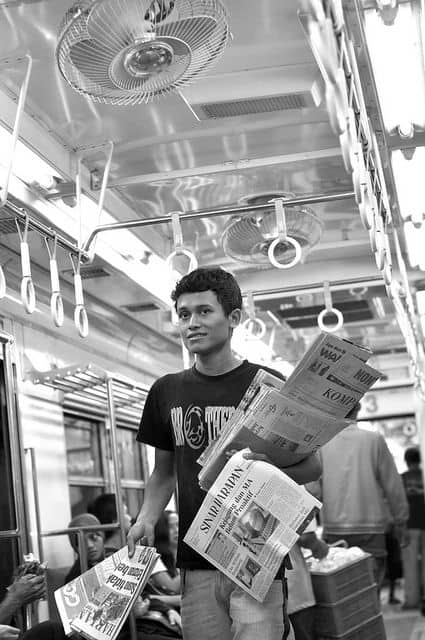 Aan Kasman - Evening newspapers - A young man offers the Indonesia's evening newspaper inside the train. (CC BY 2.0)